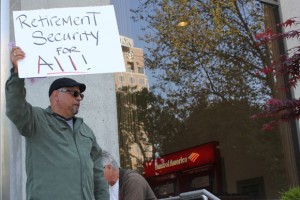 Ruben Garcia, Santa Clara Eligibility Workers Vice Chair holding retirement security sign